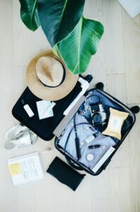 Open suitcase with folded clothing and travel belongings, photographed by Marissa Grootes; general packing context, not a hotel room or laundry facility.