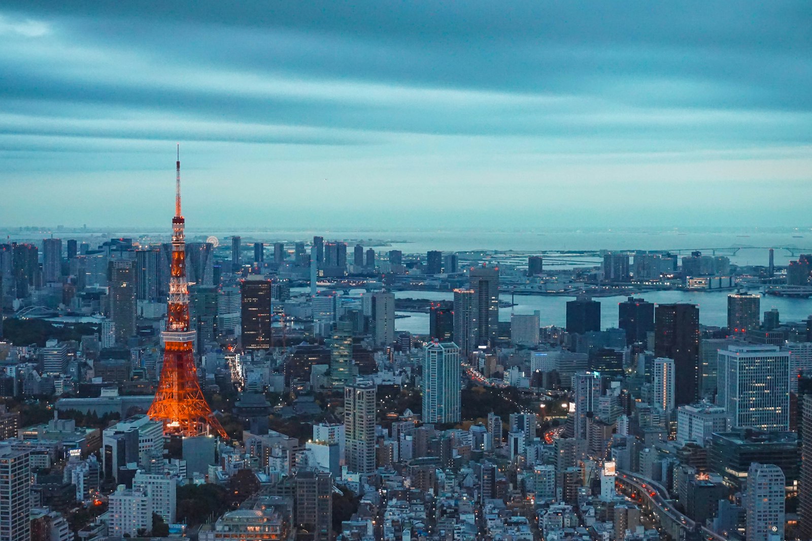Tokyo skyline with Tokyo Tower at dusk; city illustration for a Tokyo trip planning guide.